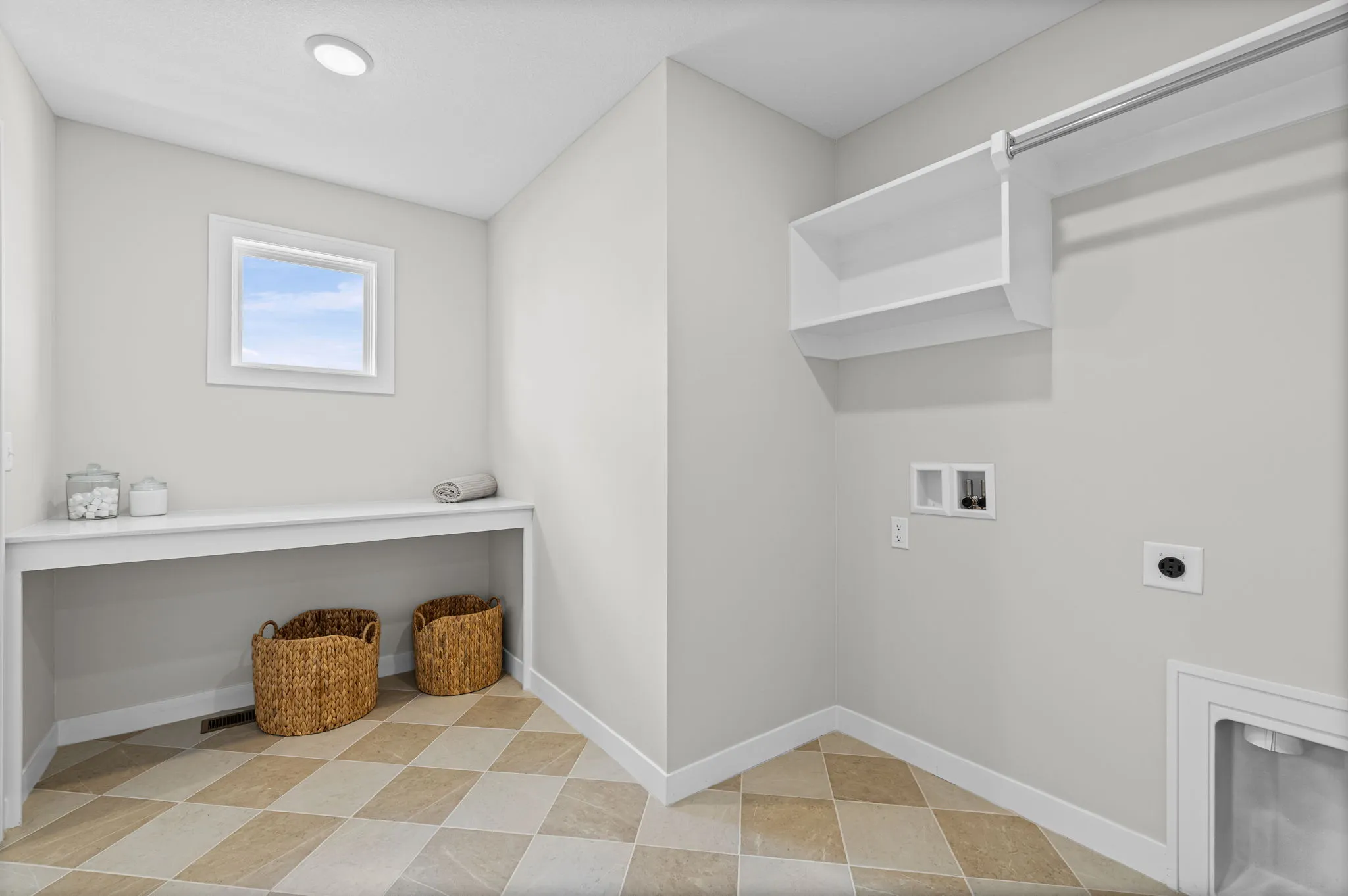 Laundry room with diagonal tile flooring, white cabinetry, shelving, and a small window.