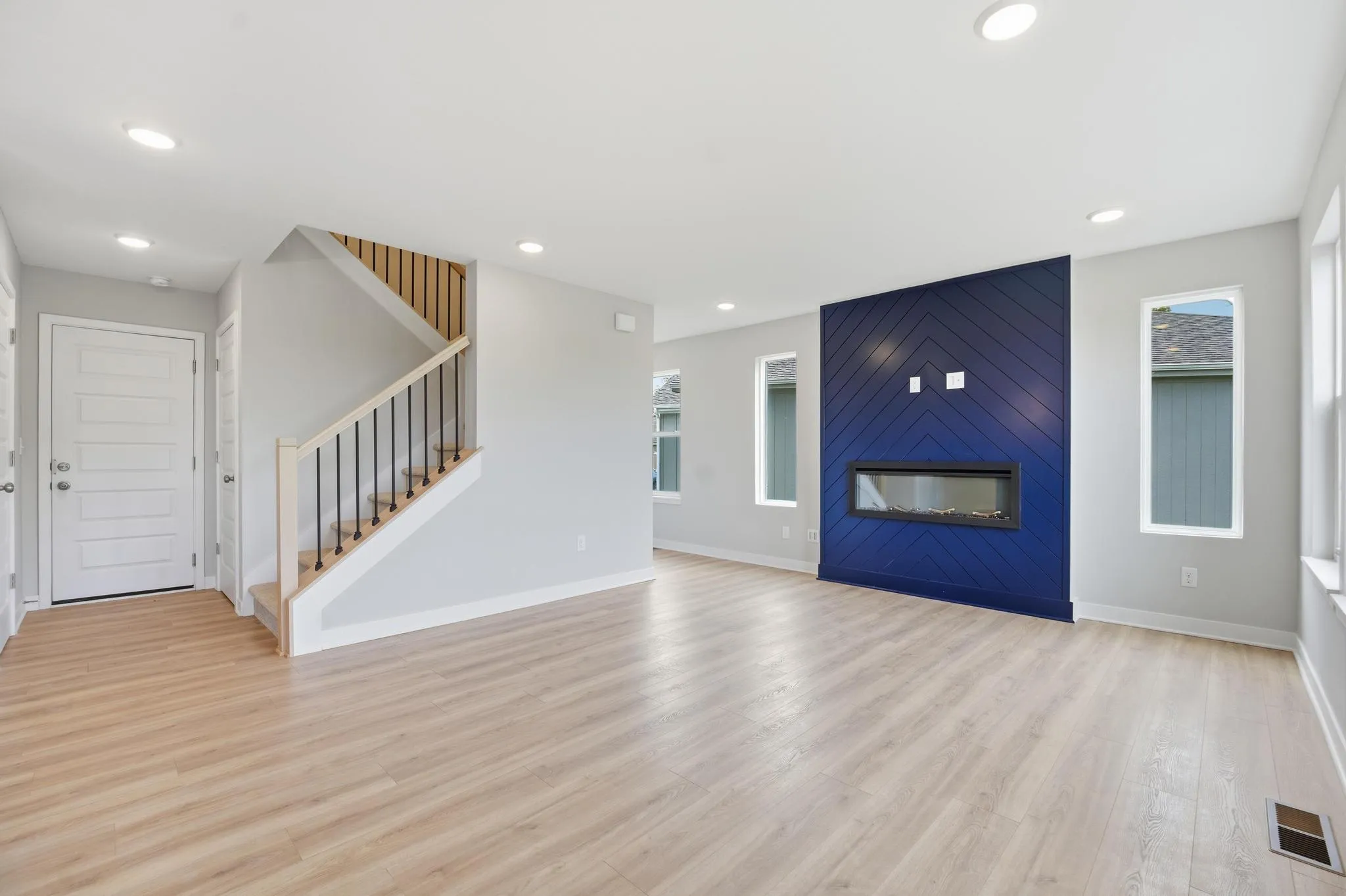 Living room with fireplace and upper level stairs featured in the Gardenia Farmhouse Floorplan 808 Glen Cir. Lot 144