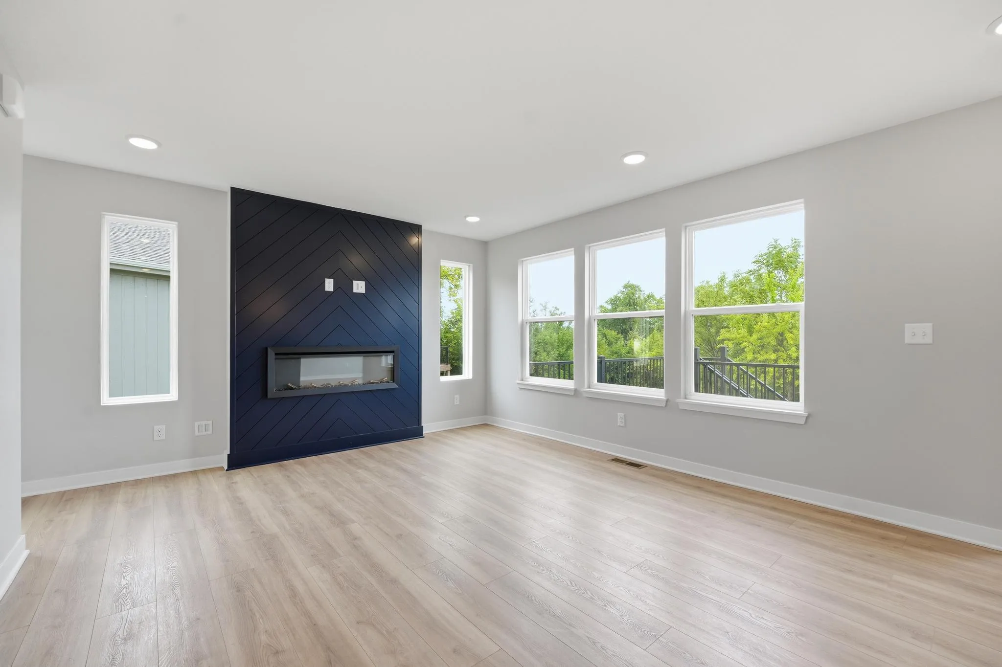Large windows and fireplace living room featured in the Gardenia Farmhouse Floorplan 808 Glenn Cir. Lot 144